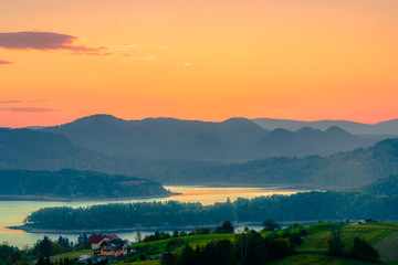 Fototapeta premium Polanczyk, Bieszczady Mountains, Poland: Sun rising over Solina Lake. Views from near hill.