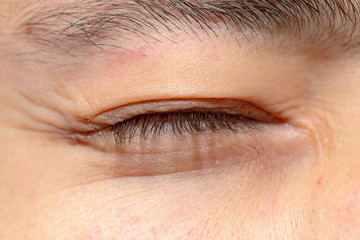 Fototapeta na wymiar Close up of closed eyes of a young caucasian man