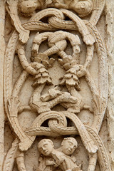 Fototapeta na wymiar Cattedrale di Bitetto; decorazione con tralci e figure fantastiche sullo stipite del portale principale