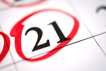 Red circle marked with pen on a calendar sheet 21 date