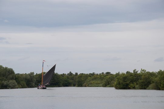 Traditional British sailing boat: a Norfolk Wherry, on a grey day
