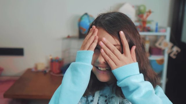 peek a boo. little girl covered her eyes face with her hands hide-and-seek waiting for a surprise. slow motion video. teen girl playing bo-peep. childhood concept lifestyle game hy - spy