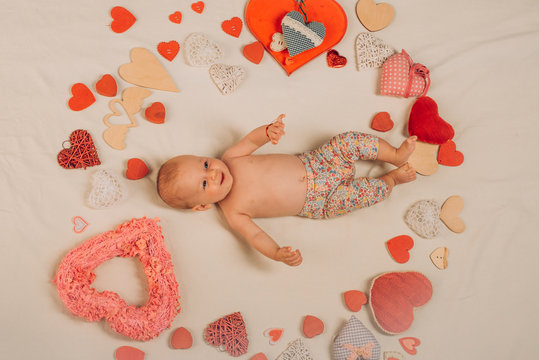 You are my heart. Love. Portrait of happy little child. Sweet little baby. New life and birth. Family. Child care. Small girl among red hearts. Childhood happiness.Valentines day