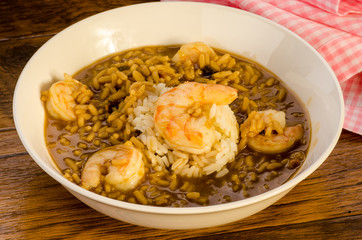 Shrimp Gumbo on Rustic Wood Table with Pink Gingham Napkin
