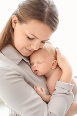 Fototapeta na wymiar Young mother with her newborn baby, closeup