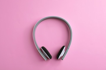 Wireless headphones on color background, top view