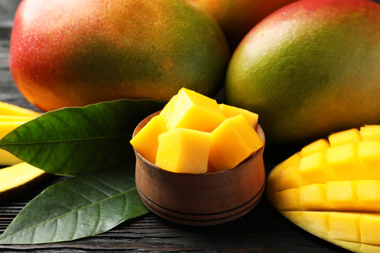 Composition with fresh mango on table, closeup