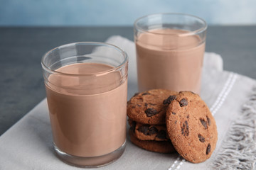 Glasses with tasty chocolate milk on table. Dairy drink