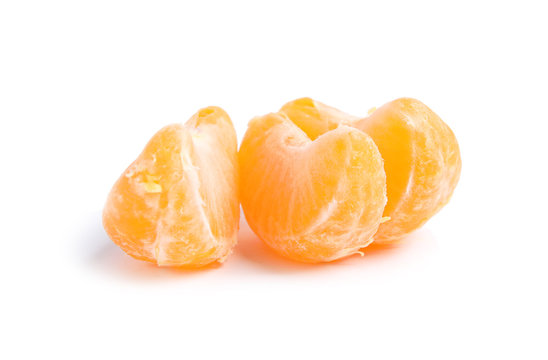 Pieces of ripe tangerine on white background