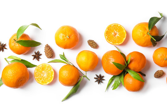 Christmas composition with ripe tangerines on white background, flat lay