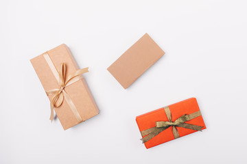 Three gifts on white table, view from above