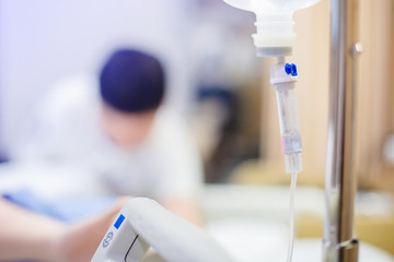 Selective focus to Infusion pumps and saline bag with blurry patient