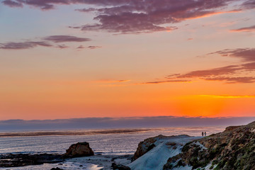 Fototapeta na wymiar Orange Sunset Along Beach