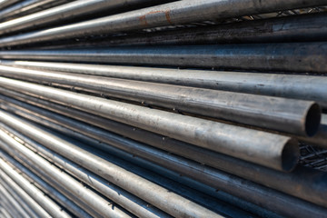 Stack of steel pipes for the construction of scaffolding.