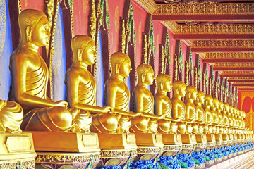 Fototapeta premium Golden statues of Arhat / Arahant / or Buddhist saints at Wat Bang Thoeng, Krabi province, Thailand. Selective focus.