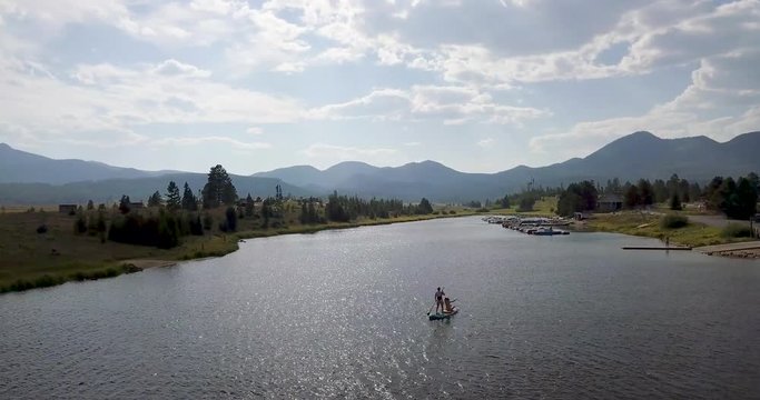 Gliding Past Two Women on a Paddleboard