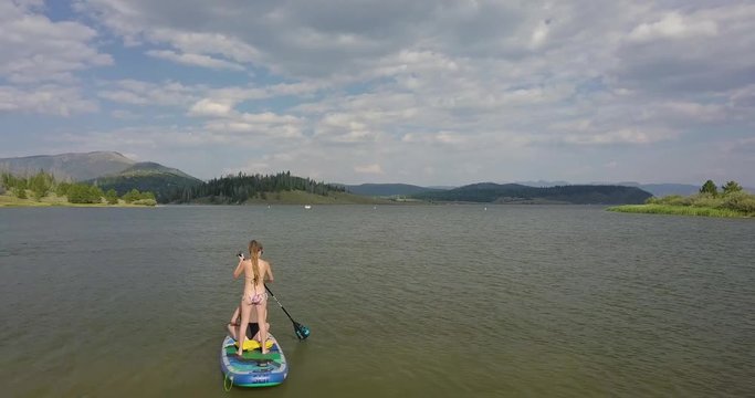 Slowly Ascending over Two Women on a Paddleboard