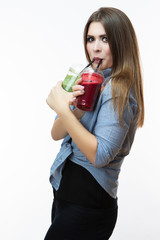 Healthy Food Eating. Woman Drinking With Both Green and Red Detox Vegetable Smoothie. Posing in Striped Blue-White Shirt Over White.