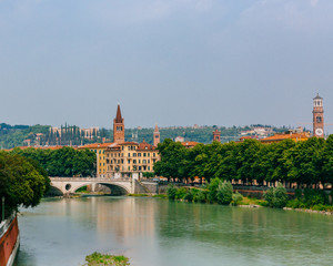 Adige river by the historical center of Verona, Italy, with towers and architecture