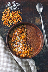 Chocolate breakfast bowl with granola and chocolate yogurt.