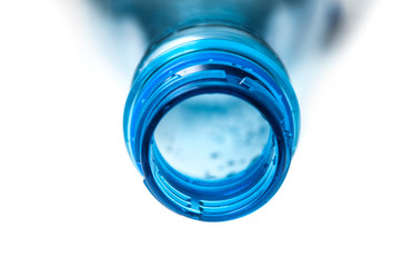 closeup of open plastic bottle neck on white background