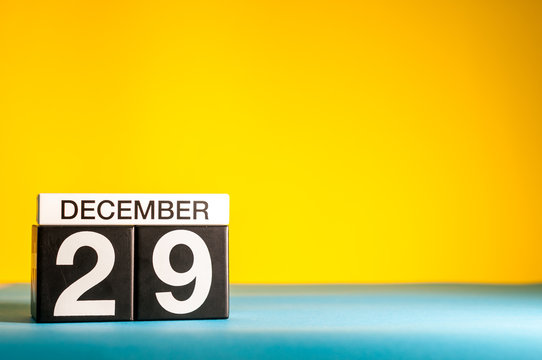 December 29th. Image 29 day of december month, calendar on yellow background with empty space for text