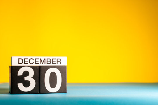 December 30th. Image 30 day of december month, calendar on yellow background with empty space for text