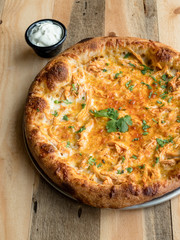 Savory buffalo chicken pizza. A tangy and spicy pizza topped with mozzarella and chicken.