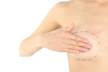 Young woman with marks on breast for cosmetic surgery operation against white background, closeup