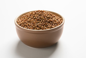 Bowl with buckwheat on white background. Natural food high in protein