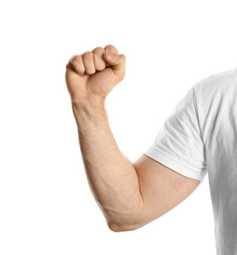 Young man showing clenched fist on white background