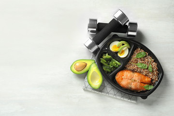 Flat lay composition with container of natural protein food on light background. Space for text