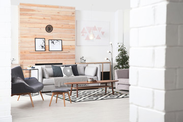 Stylish living room interior with comfortable couch and decorative elements