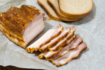 English bacon partially sliced on Kraft paper