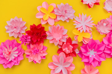 Flower made of coral color paper. The pink color of the curl and leaf.