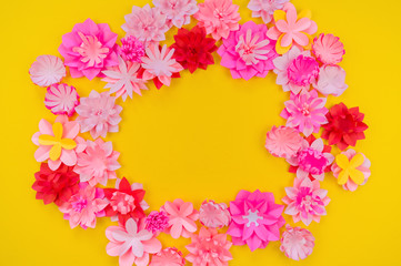 Flower made of coral color paper. The pink color of the curl and leaf.