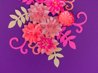Flower made of coral color paper. The pink color of the curl and leaf.