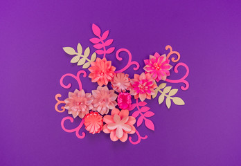 Flower made of coral color paper. The pink color of the curl and leaf.
