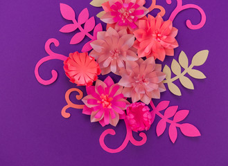 Flower made of coral color paper. The pink color of the curl and leaf.