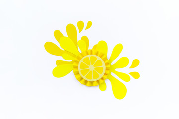 Yellow lemon with splashes made of paper on a white background. Fruit smoothies vegetarian.