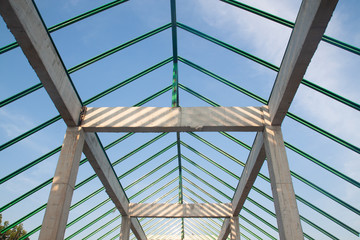 Structure of steel and concrete for building construction on blue sky background.