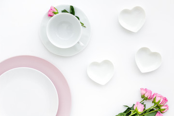 set-up table with plates and flower on white background top view