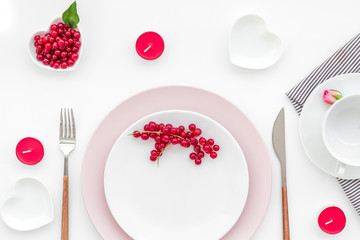 Empty white and pink colorful plate with wineberry for table setting on white table backgroung top view