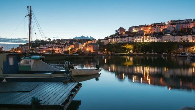 4K Timelapse of Brixham Harbour at sunrise and many houses with the wonderful sky. Brixham is a small fishing village. Brixham, England.