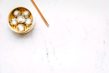 Chinese food set with dim sum, sticks on marble background top view copy space