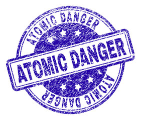 ATOMIC DANGER stamp seal imprint with grunge style. Designed with rounded rectangles and circles. Blue vector rubber print of ATOMIC DANGER label with grunge texture.