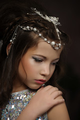 Little girl in a silver dress. Caucasian, attractive.
