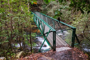 A metal footbridge over the Little Gizzard Creek just upstream Foster Falls in Sequatchie Tennessee. This is part of the Fiery Gizzard Trail in the Cumberland Plateau.