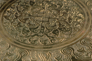 Eastern engraving on bronze, close-up