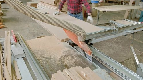 A Man Saws Wooden Door Blanks On The Machine The Production